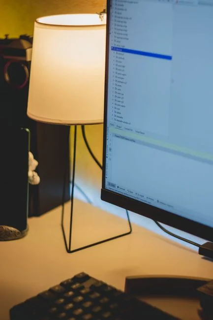 High-angle view of a stylish work desk featuring dual monitors, keyboard, mouse, and modern accessories.
